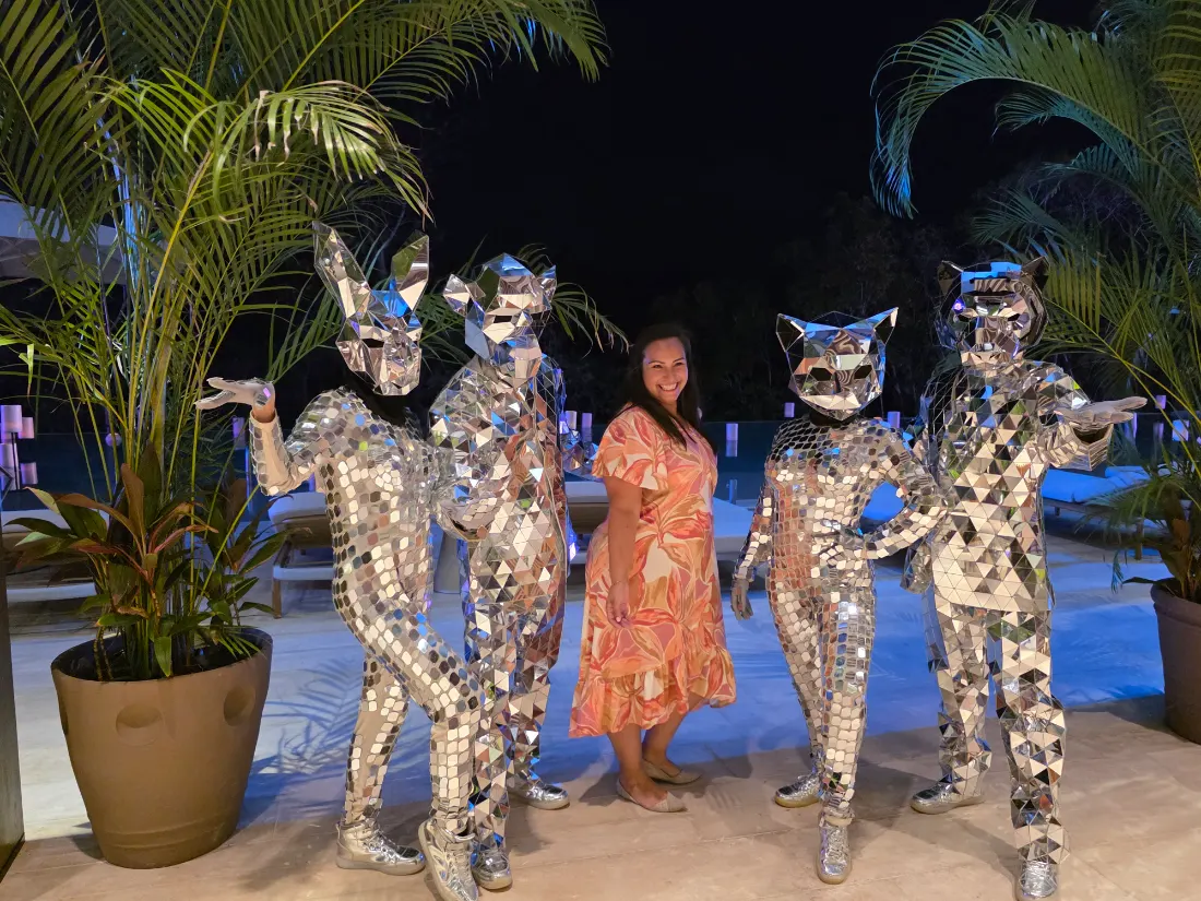 Mirror-suit performers at a poolside night party — Safari Feast