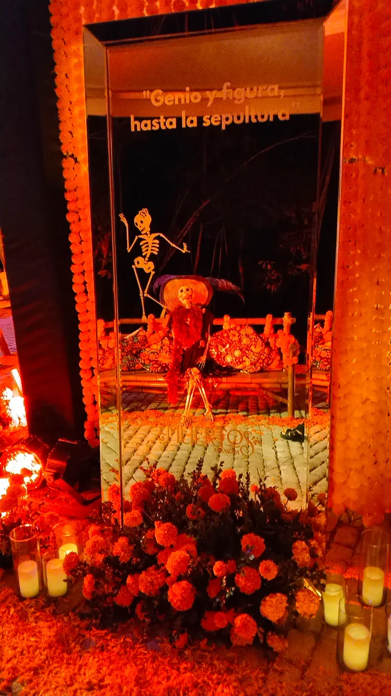 Día de Muertos mirror altar with marigolds and candles