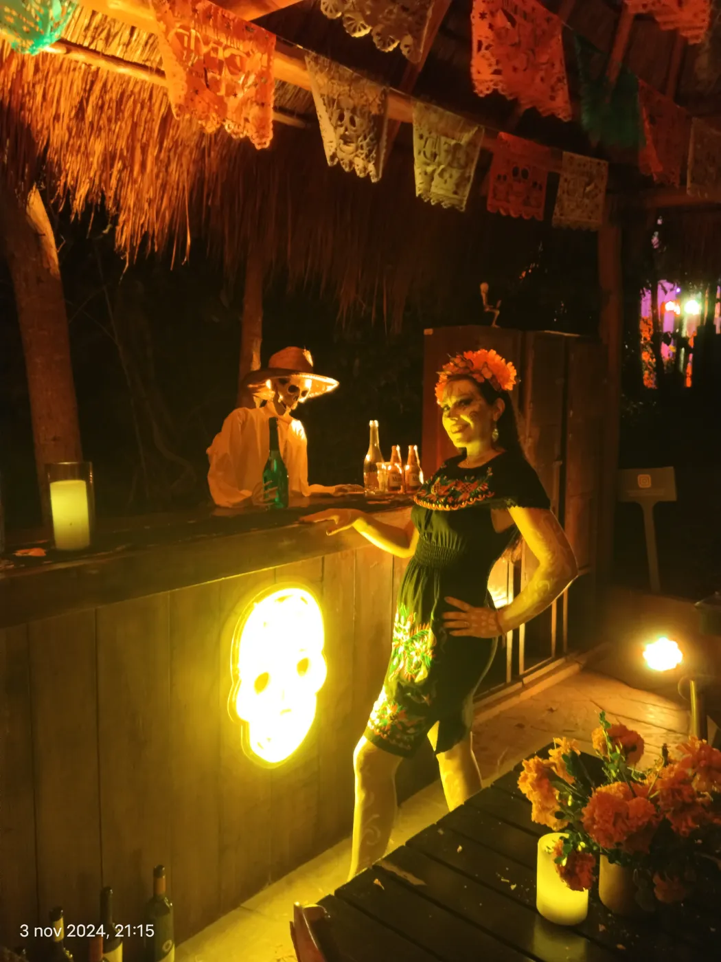 Themed skull bar with a Catrina host at a Día de Muertos event