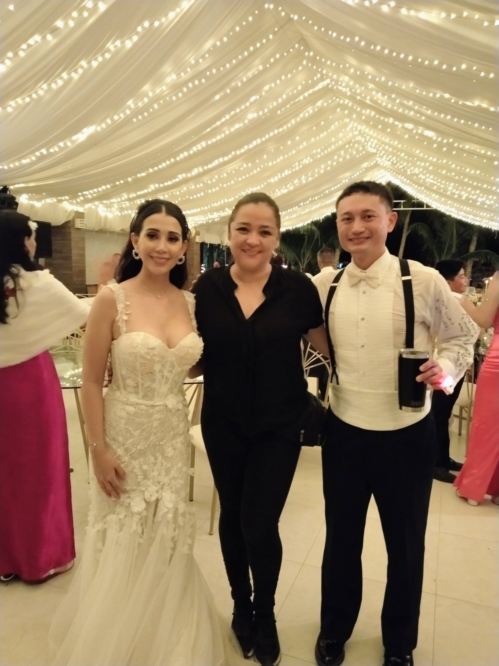 Bride and groom with their Safari Feast planner at a Riviera Maya reception