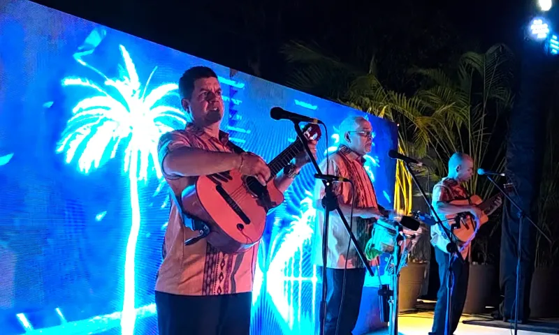 Trova trio performing live on stage at an evening event